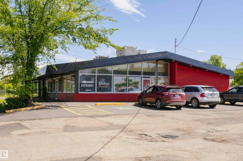 Commercial building featuring a red facade and a black sloped roofline - #208 9907 91 Av Nw, Edmonton, AB - Outdoor
