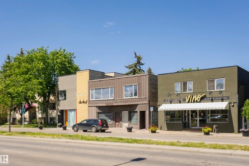 Commercial street frontage with varied architectural styles, including stucco, brick, and vertical siding - #208 9907 91 Av Nw, Edmonton, AB - Outdoor