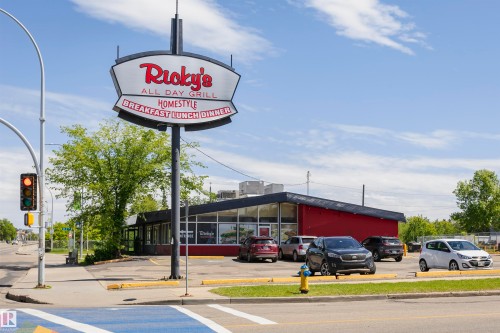Freestanding commercial building featuring a prominent pylon sign and a red facade with extensive window lines - #208 9907 91 Av Nw, Edmonton, AB - Outdoor