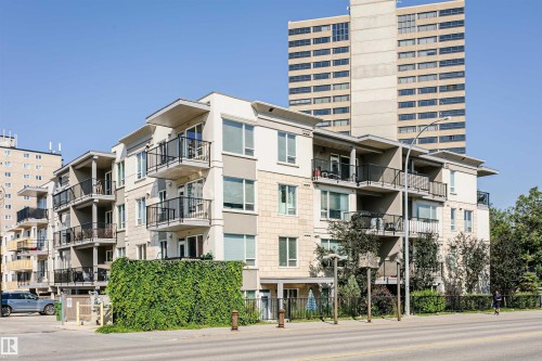 Contemporary multi-story building featuring stone and stucco exterior finishes - #208 9907 91 Av Nw, Edmonton, AB - Outdoor With Balcony With Facade