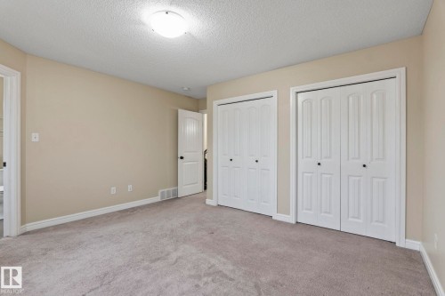 Neutral wall color, carpet flooring, two bi-fold closet doors, and recessed ceiling lighting - 1209 30 Avenue Nw, Edmonton, AB - Indoor