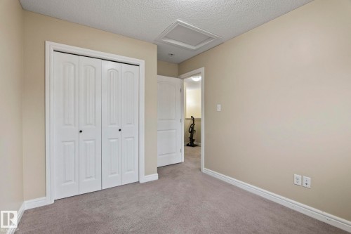Neutral-toned walls, textured ceiling, and gray carpeting - 1209 30 Avenue Nw, Edmonton, AB - Indoor
