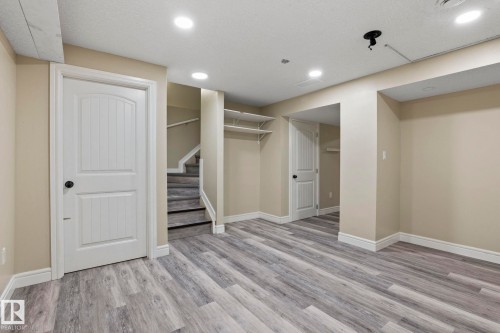 Light-toned walls, recessed ceiling lighting, and wood-finish flooring - 1209 30 Avenue Nw, Edmonton, AB - Indoor
