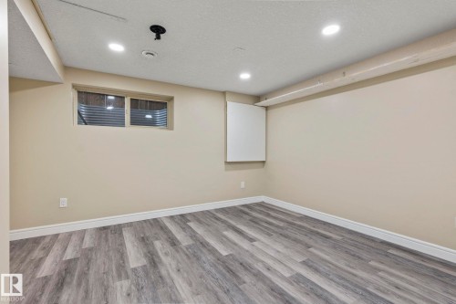 Recessed ceiling lighting, wood-finish flooring, white trim, neutral wall color, and a window - 1209 30 Avenue Nw, Edmonton, AB - Indoor