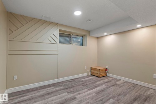 Recessed lighting illuminates the wood-finish flooring - 1209 30 Avenue Nw, Edmonton, AB - Indoor
