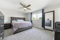Recessed lighting, ceiling fan with integrated lighting, large window, and light gray carpeting - 