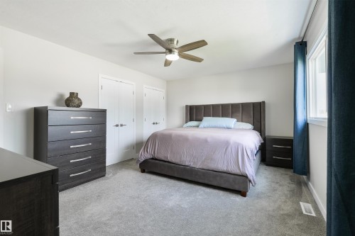 Recessed lighting, ceiling fan with light fixture, light gray carpeting, and multiple windows - 4614 53 Ave, Calmar, AB - Indoor Photo Showing Bedroom