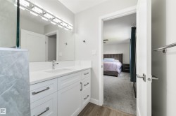 White vanity with integrated sink, chrome faucet, and rectangular mirror - 