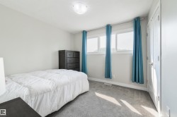 Light gray carpet flooring, white walls, and a contemporary ceiling light fixture - 