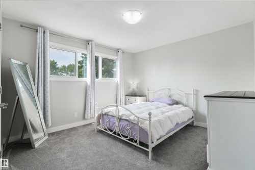 Room featuring light gray walls, gray carpet, and a flush mount ceiling light - 4614 53 Ave, Calmar, AB - Indoor Photo Showing Bedroom