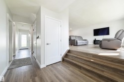 Tiered living space with wood-finish flooring - 