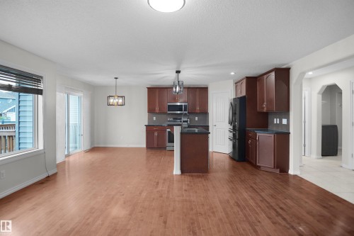 Open-concept living space with wood-finish flooring - 8432 18 Avenue Sw, Edmonton, AB - Indoor Photo Showing Kitchen