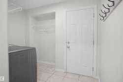 White paneled door with polished chrome hardware, durable tile flooring, and integrated wire shelving - 