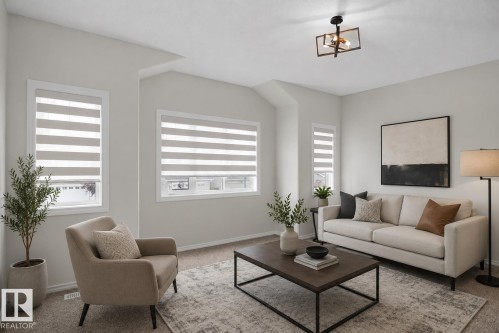 Living area with neutral wall tones and recessed lighting - 8432 18 Avenue Sw, Edmonton, AB - Indoor Photo Showing Living Room
