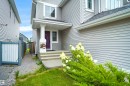 Light gray horizontal siding, front entry with a purple door, white trim, and a covered porch - 8432 18 Avenue Sw, Edmonton, AB  - Outdoor 