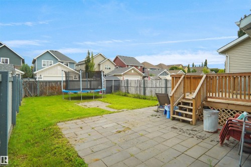Expansive backyard featuring a paver patio and a wooden deck with railing - 8432 18 Avenue Sw, Edmonton, AB - Outdoor With Deck Patio Veranda