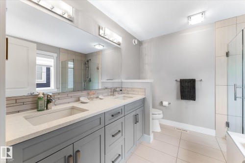 Dual vanity with integrated sinks and gray cabinetry - 5616 Juchli Avenue Nw, Edmonton, AB - Indoor Photo Showing Bathroom