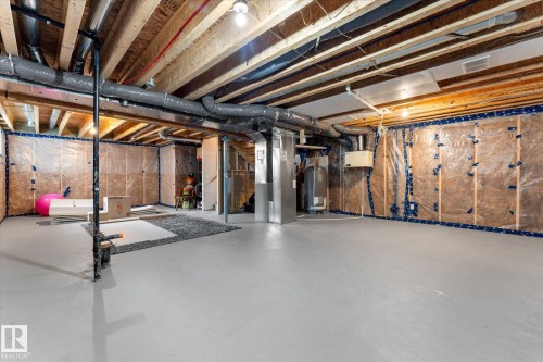 Spacious interior with polished concrete flooring, exposed beam ceiling structure, and abundant natural light - 5616 Juchli Avenue Nw, Edmonton, AB - Indoor Photo Showing Basement