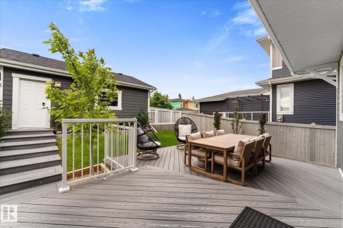 Multi-level composite deck with white railings and integrated steps - 5616 Juchli Avenue Nw, Edmonton, AB - Outdoor With Deck Patio Veranda With Exterior