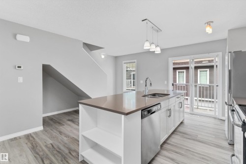 #98 4050 Savaryn Dr Sw, Edmonton, AB - Indoor Photo Showing Kitchen With Double Sink With Upgraded Kitchen