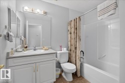 Recessed vanity with integrated sink, chrome faucet, and overhead lighting fixture - 
