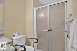 Shower enclosure with frosted glass panels and white framing - 