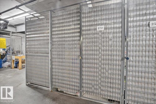 Individual storage units featuring metal mesh construction and concrete flooring - #116 237 Youville Dr E Nw, Edmonton, AB - Indoor