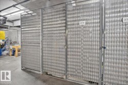 Individual storage units featuring metal mesh construction and concrete flooring - 