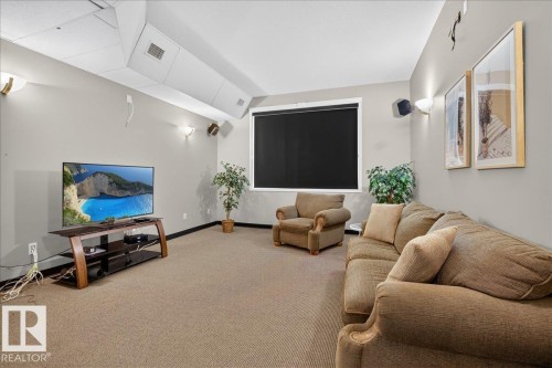 Carpeted room with recessed lighting and a window featuring a roller shade - #116 237 Youville Dr E Nw, Edmonton, AB - Indoor Photo Showing Other Room