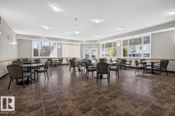 Spacious room featuring multiple large windows, recessed ceiling lights, sconce lighting, and durable tile flooring - 