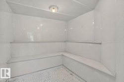 Built-in bench seating with a white finish, white wall paneling, and a floor featuring white hexagonal tile - 