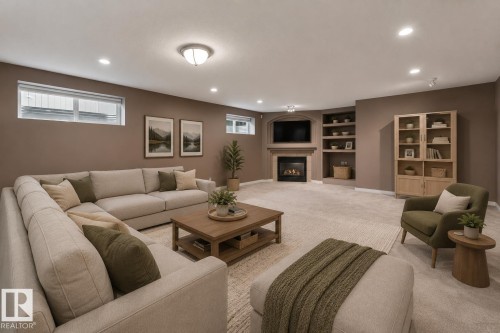 Recessed lighting, corner fireplace, built-in shelving, and light-colored carpeting - 8 Osborne Close, St. Albert, AB - Indoor With Fireplace
