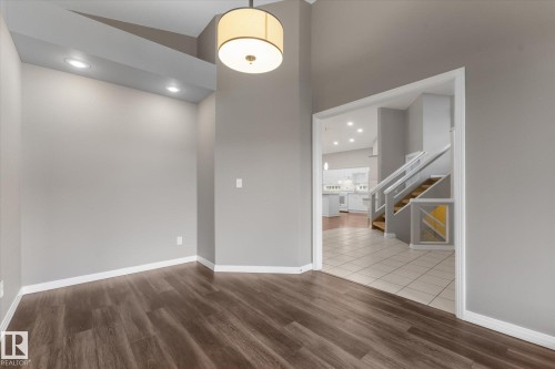 Wood-finish flooring, recessed lighting, drum pendant light, vaulted ceiling, and white trim - 8 Osborne Close, St. Albert, AB - Indoor Photo Showing Other Room