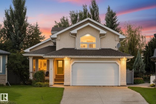 Stucco exterior with a peaked roofline, arched window, and attached garage - 8 Osborne Close, St. Albert, AB - Outdoor