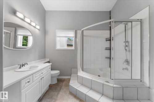 White vanity with a single basin sink and chrome faucet - 8 Osborne Close, St. Albert, AB - Indoor Photo Showing Bathroom