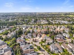 Residential neighborhood featuring an abundance of mature trees and a clear blue sky - 