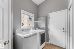 Utility room with ceramic tile flooring, a window, and built-in shelving - 