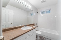 Full vanity with a single basin sink, integrated countertop, and storage cabinetry - 
