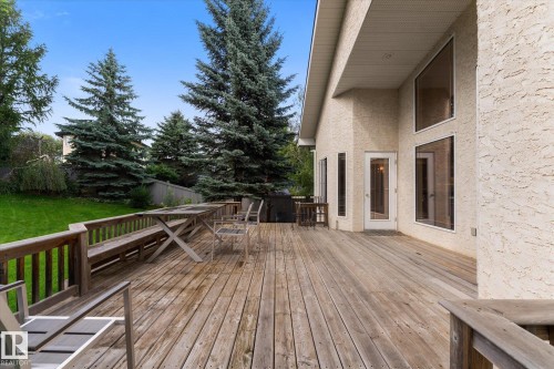 Expansive wood deck with a built-in bench, offering direct access to the interior through a glass-paneled door - 8 Osborne Close, St. Albert, AB - Outdoor With Deck Patio Veranda