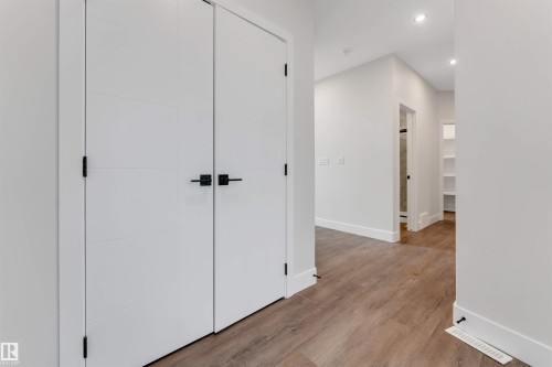 Hallway featuring wood-finish flooring, white walls, and recessed lighting - 329 Balsam Link, Leduc, AB - Indoor Photo Showing Other Room