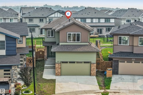 Contemporary two-story residence featuring multi-tone siding and stone accents - 329 Balsam Link, Leduc, AB - Outdoor With Facade