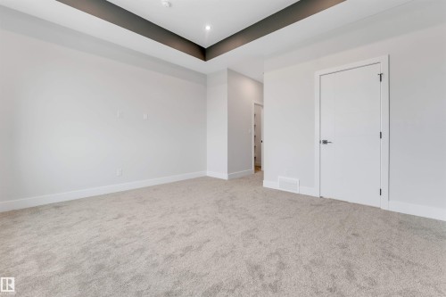 Spacious room featuring plush carpeting, crisp white walls, and a recessed ceiling with dark accent trim - 329 Balsam Link, Leduc, AB - Indoor Photo Showing Other Room