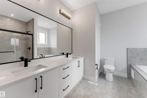 Double vanity with integrated sinks, quartz countertop, and matte black fixtures - 329 Balsam Link, Leduc, AB - Indoor Photo Showing Bathroom