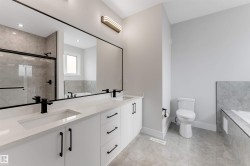 Double vanity with integrated sinks, quartz countertop, and matte black fixtures - 
