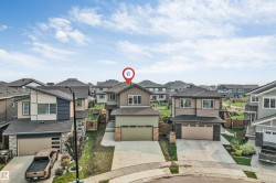 Modern two-story residence featuring a two-tone exterior, attached front-entry garage, and a concrete driveway - 