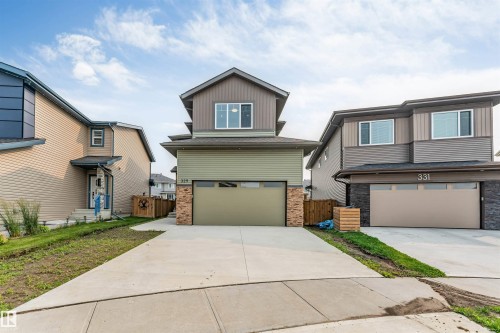 Contemporary exterior featuring multi-toned siding and stone veneer accents - 329 Balsam Link, Leduc, AB - Outdoor With Facade