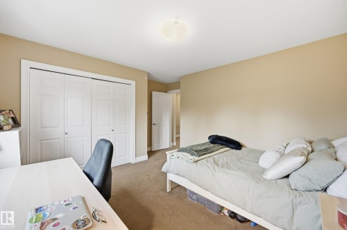 Neutral wall tones with carpeted flooring - 2416 Warry Place Sw, Edmonton, AB - Indoor Photo Showing Bedroom