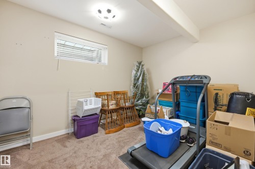 Carpeted flooring, recessed window, exposed ceiling beam, and flush-mount ceiling light - 2416 Warry Place Sw, Edmonton, AB - Indoor
