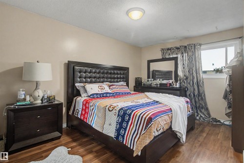 Wood-finish flooring throughout - 5724 143 Avenue Nw, Edmonton, AB - Indoor Photo Showing Bedroom
