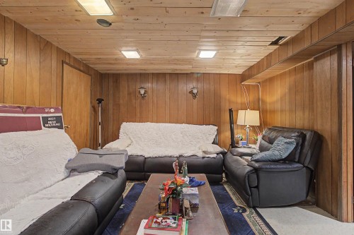 Wood paneling walls with matching wood-finish ceiling, featuring recessed lighting and wall-mounted sconces - 5724 143 Avenue Nw, Edmonton, AB - Indoor Photo Showing Other Room